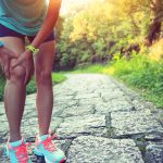Woman runner hold her sports injured knee. Athlete, female.