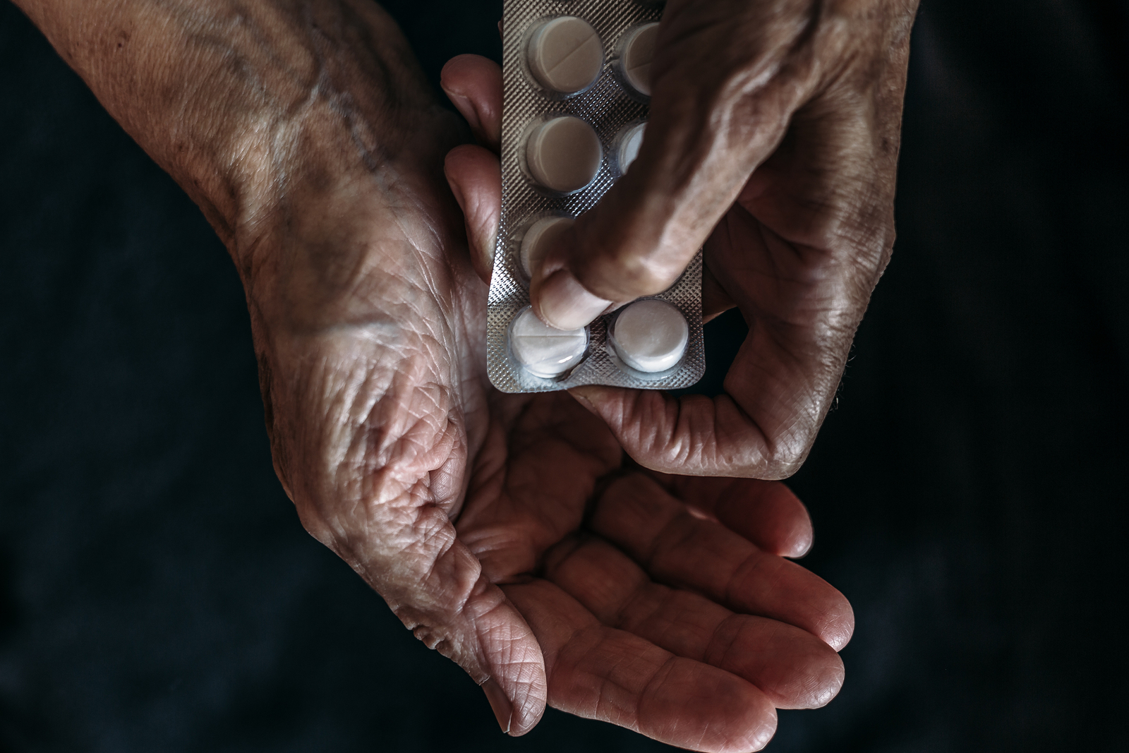 Old lady taking medications