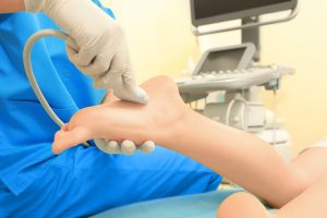 ultrasound examination of patient's foot in cl