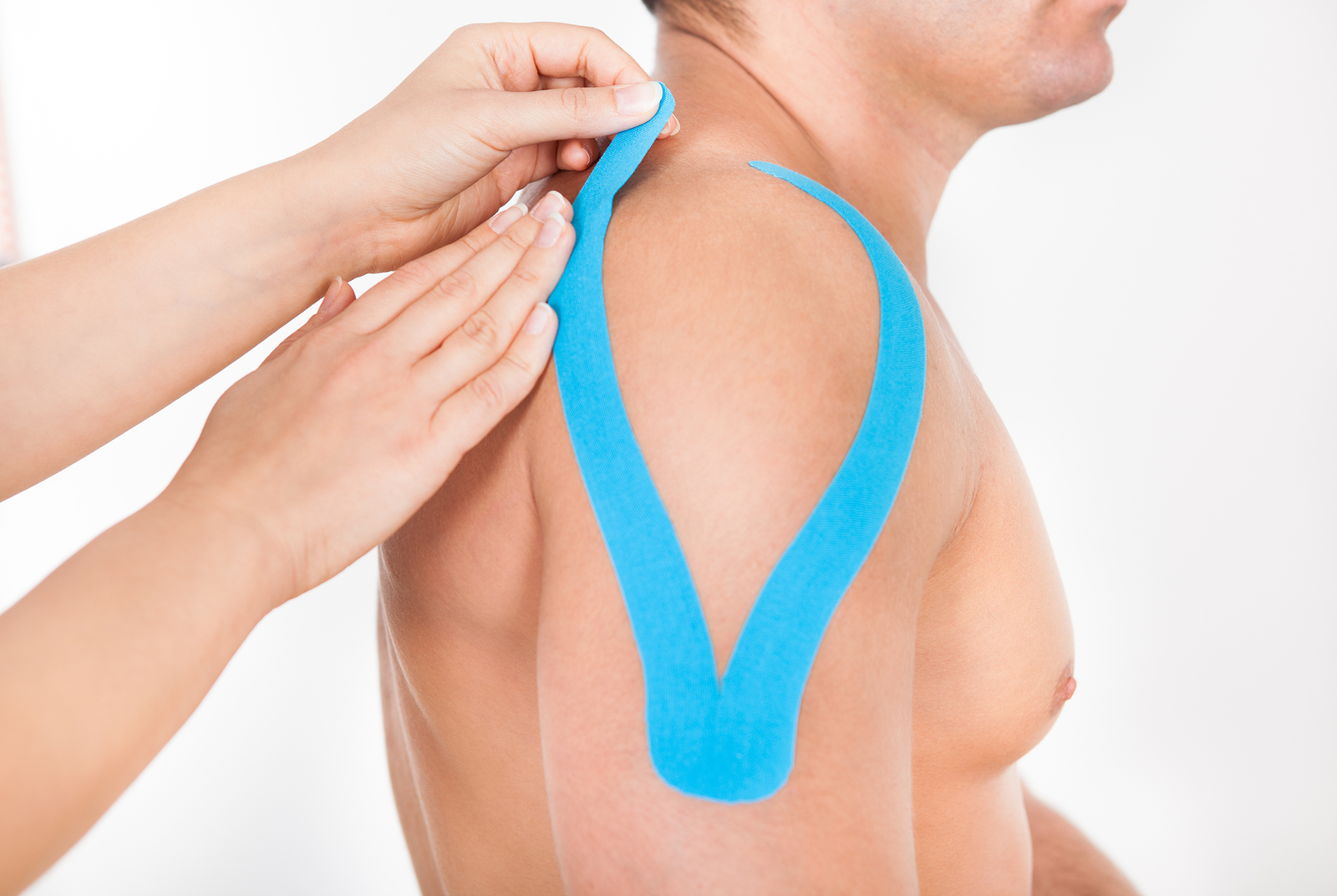 Person Applying Physio Tape To Man