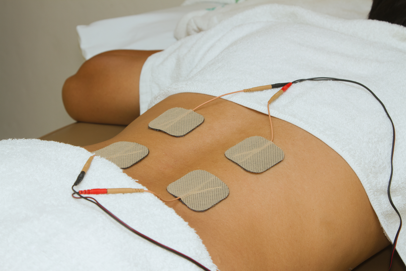 Patient Applying Electrical Stimulation Therapy ( Tens ) On His