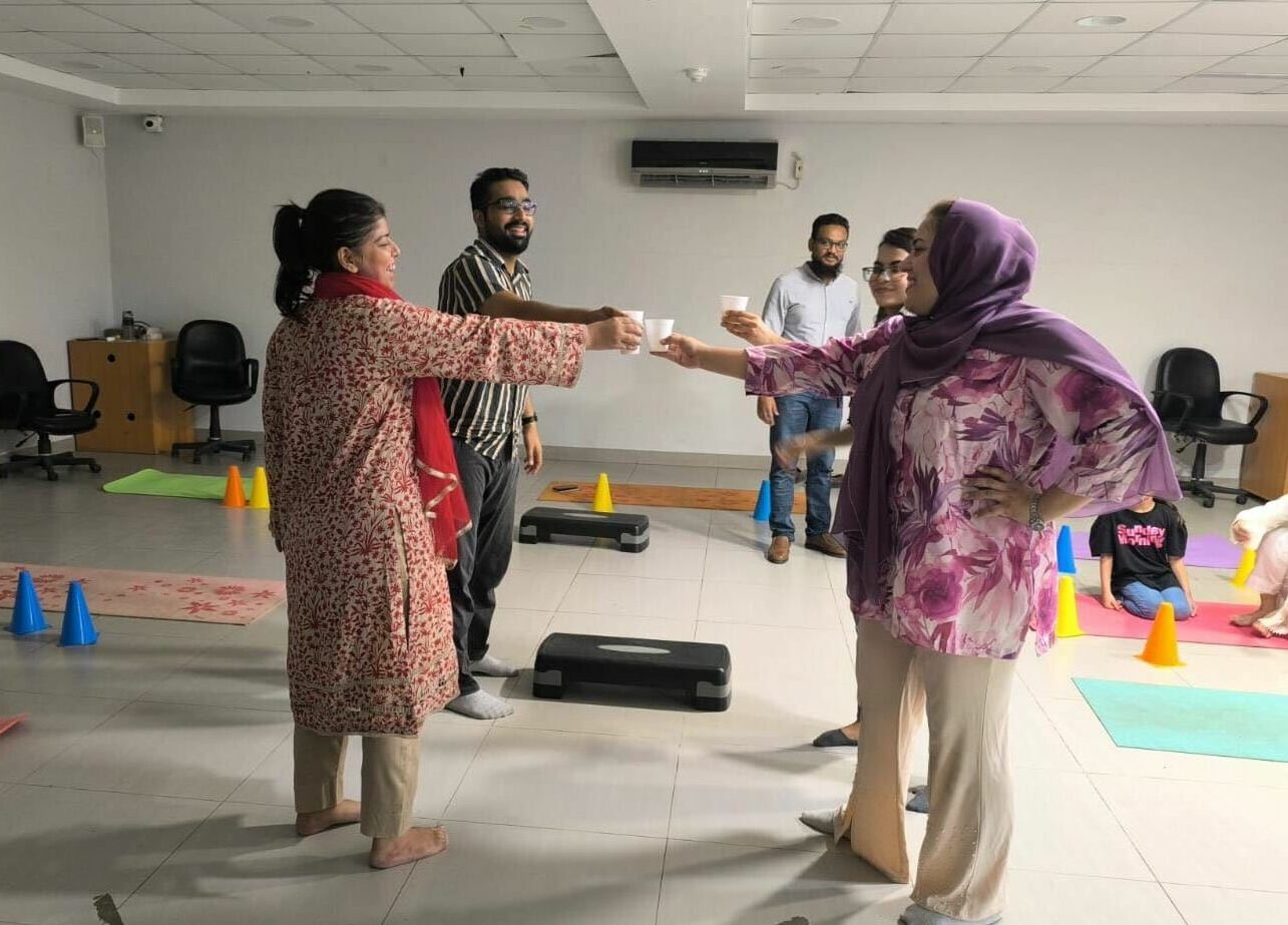 Image shows participants of a novel class-based physical activity programme sharing a drink break amongst exercise equipment. Image links to the Physical Activity Programme of online courses on Physiopedia Plus onlnine learning for Physiotherapists, Physical Therapists and Rehabilitation Professionals.
